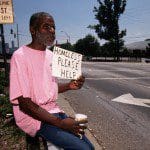 RI002188 Homeless Man Holds Sign for Help --- Image by © Bob Krist/CORBIS