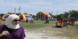 Children had multiple ways to play together while expressing subtle message to adults. A muslim sister casually walks past. Karsceal Turner-MRS