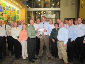 Sam Pero, Regional Director of Publix Super Markets Inc. delivers $117,000 check to Dave Krepcho, CEO/President of Second Harvest Food Bank of Central Florida, which was generated by Publix’s Food for All seasonal donation campaign.