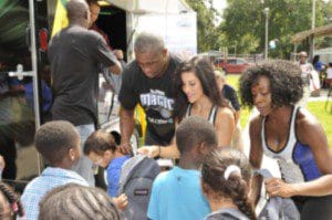  Magic Dancers along with Magic Community Ambassador Nick Anderson helps hand out backpacks to youth from Parramore Kidz Zone as part of the Magic’s Back to School Celebration on Weds., Aug. 7 at the Callahan Center.  The Magic teamed with Dixon Ticonderoga and Amway to provide backpacks filled with school supplies to help prepare the students for the upcoming school year. (Photo: Orlando Magic)