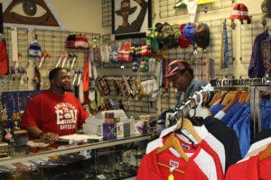 Shop keeper, Charles Thomas, chats with a patron at his Bookstore "In the Beginning" (Photo credit: K. Turner/WONO)