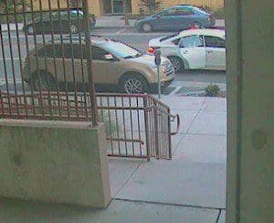 Photo of the suspect in the suspect vehicle, as he opens the rear door. (OPD)