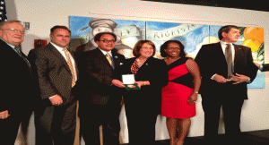 l-r: Orange County Commissioners Fred Brummer, Scott Boyd, Curtis Dean - Rosa Parks' godson, Mayor Teresa Jacobs, Commissioner Tiffany Moore Russell and Pete Clarke pose in front of the newly unveiled mural the 50th Anniversary of the Civil Rights Act of 1964, at the Orange County Regional History Center, July 2, 2014. (Photo: WONO)