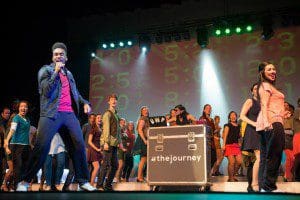 Sean Wilkins from Orlando, FL singing during a performance of "The Journey" with 100 international participants.?